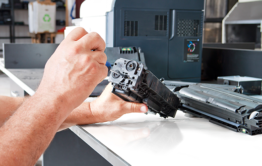 Man fixing a copier during a copy machine service in Chisholm