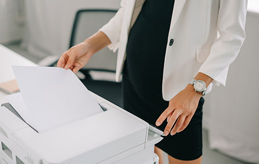 Woman using one of many Office Printers in Grand Rapids, MN, Aurora, MN, Virginia, MN, Ely, MN, Biwabik, Hoy Lakes